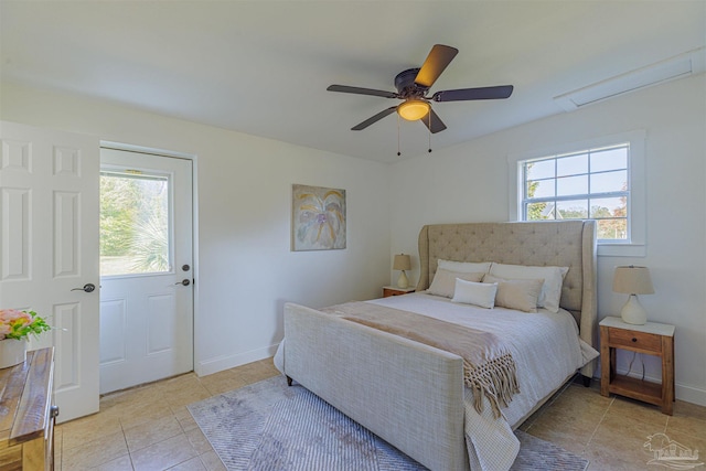 bedroom featuring light tile patterned floors, baseboards, multiple windows, and a ceiling fan