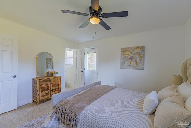 bedroom featuring light tile patterned flooring, baseboards, and ceiling fan