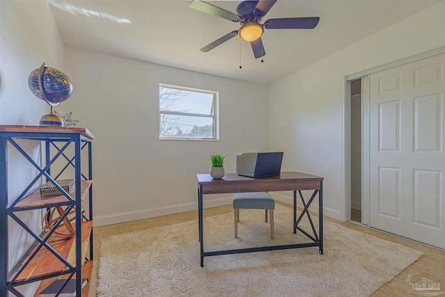 home office featuring a ceiling fan and baseboards