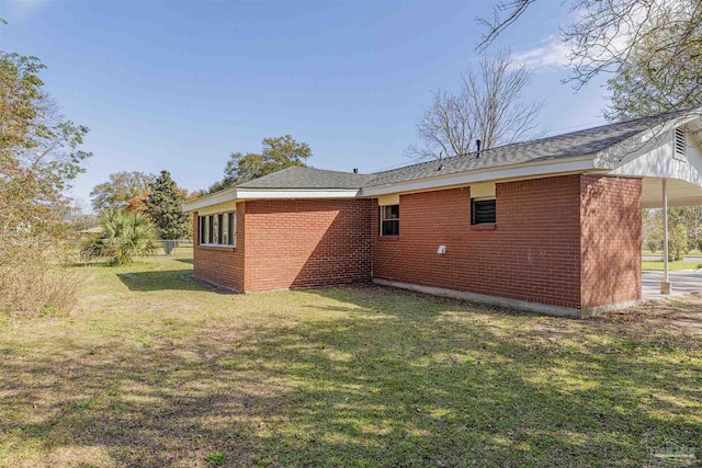 back of property with brick siding and a lawn