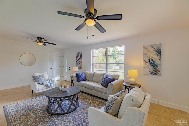 tiled living room with baseboards and a ceiling fan