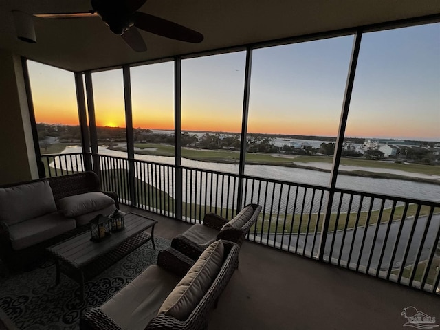 sunroom featuring outdoor lounge area, floor to ceiling windows, a water view, and a ceiling fan