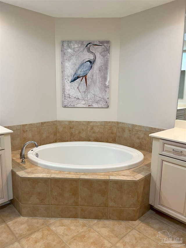 full bathroom featuring a bath, tile patterned floors, and vanity