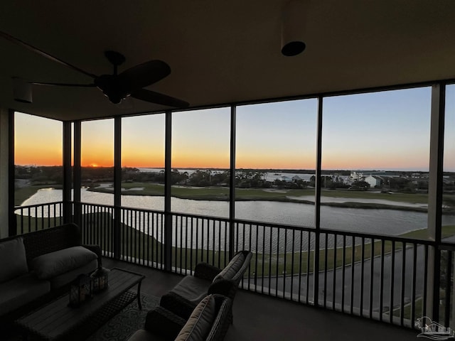 sunroom featuring a water view, wood finished floors, and a healthy amount of sunlight