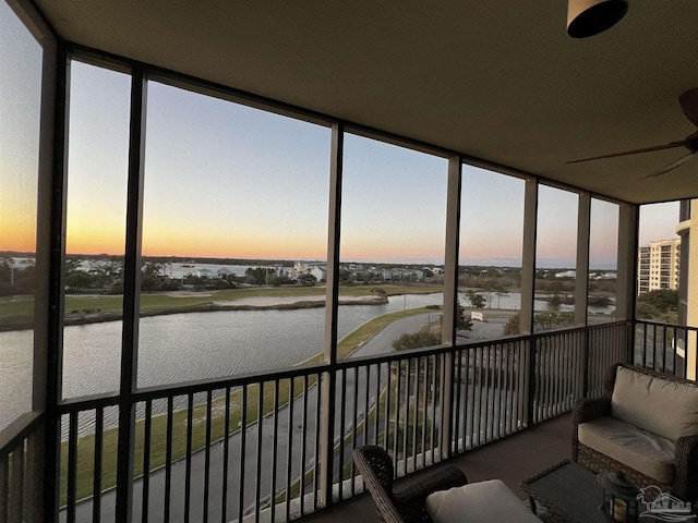 sunroom with a water view and expansive windows