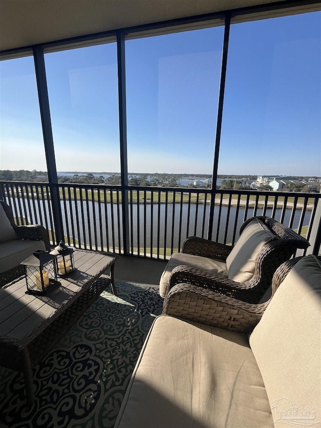 sunroom / solarium with a water view and a healthy amount of sunlight