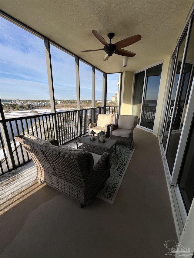 sunroom with a ceiling fan and outdoor lounge area