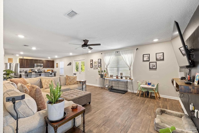 4678 Perception Cir, Milton, FL 32570 - living room featuring a ceiling fan, recessed lighting, wood finished floors, baseboards, and a textured ceiling