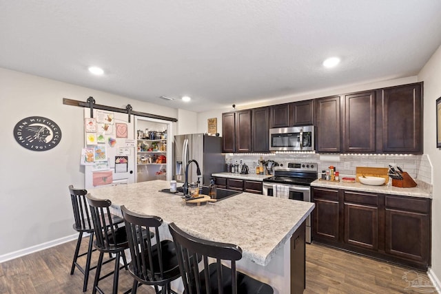 4678 Perception Cir, Milton, FL 32570 - kitchen with appliances with stainless steel finishes, a sink, a breakfast bar area, a center island with sink, and recessed lighting