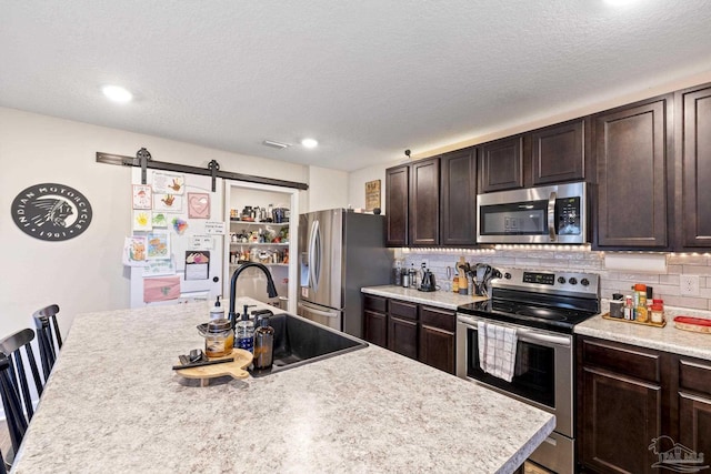 4678 Perception Cir, Milton, FL 32570 - kitchen featuring stainless steel appliances, a sink, dark brown cabinets, light countertops, and recessed lighting