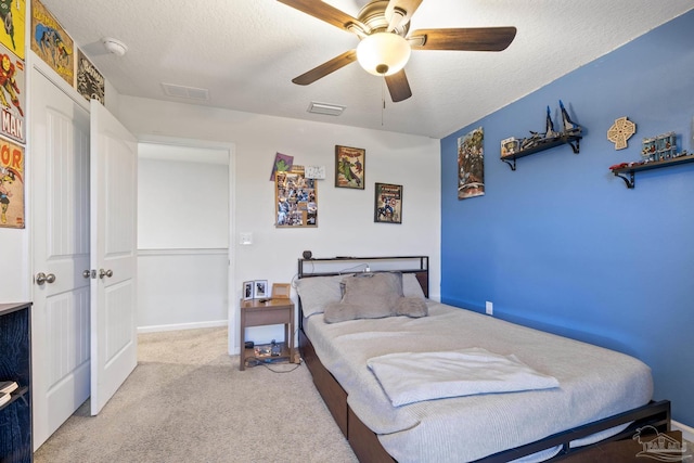 4678 Perception Cir, Milton, FL 32570 - bedroom with light colored carpet, a textured ceiling, ceiling fan, and baseboards