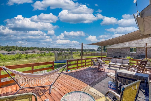 4678 Perception Cir, Milton, FL 32570 - wooden deck with a trampoline, an outdoor hangout area, and cooling unit