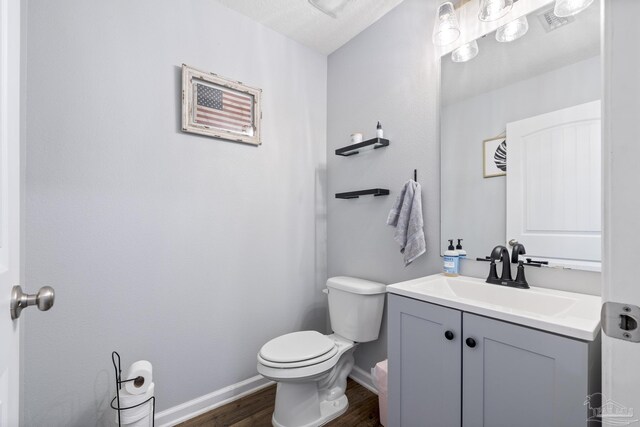 4678 Perception Cir, Milton, FL 32570 - half bathroom with wood finished floors, toilet, vanity, and baseboards