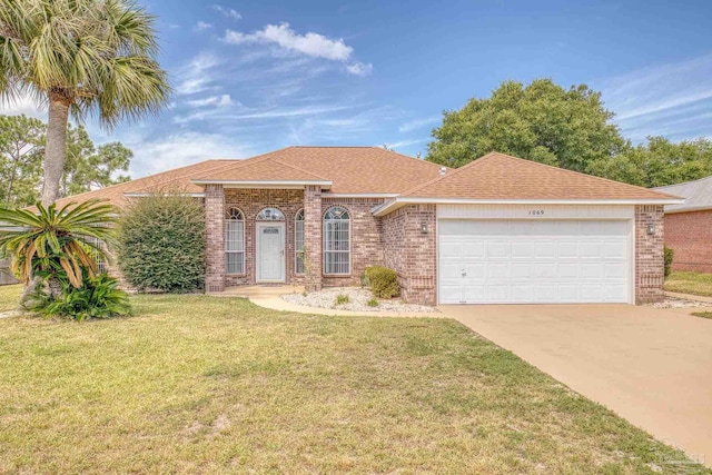 ranch-style house featuring a garage and a front yard