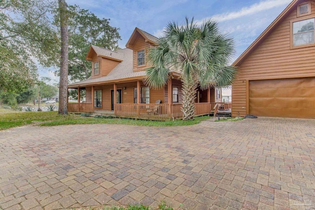 view of front of house featuring covered porch and a garage