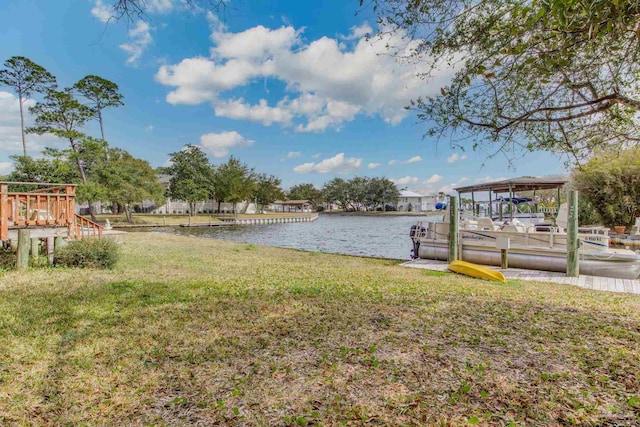 view of yard with a boat dock and a water view