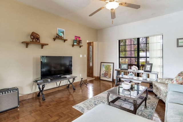 living room featuring ceiling fan and baseboards