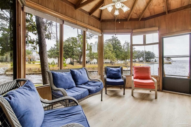 sunroom featuring vaulted ceiling with beams, wooden ceiling, a water view, and a ceiling fan