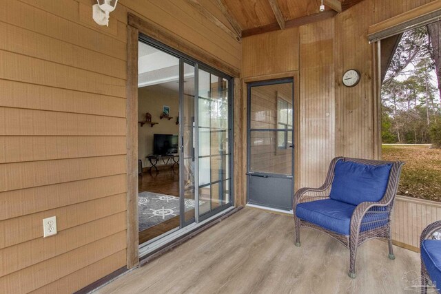 sunroom / solarium featuring vaulted ceiling