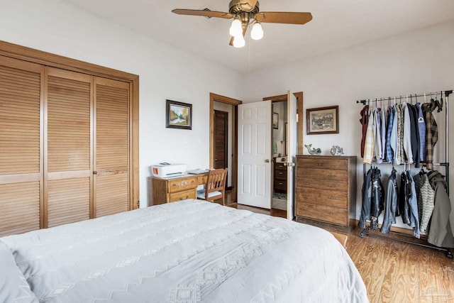 bedroom featuring a ceiling fan, a closet, and wood finished floors