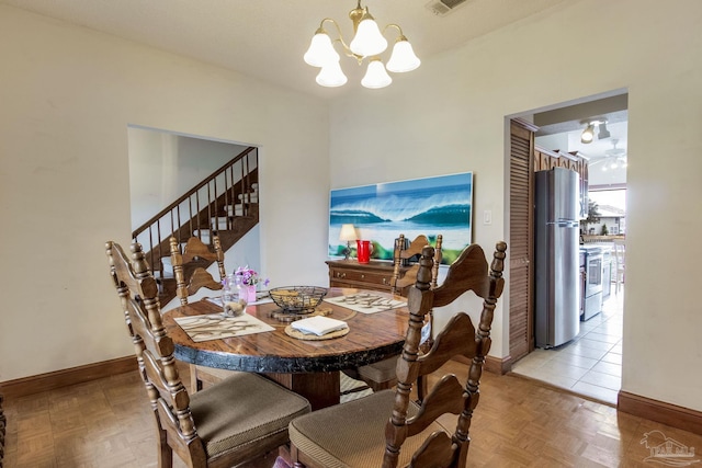 dining room featuring visible vents, baseboards, and a notable chandelier