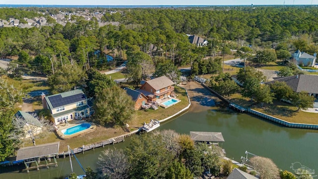 drone / aerial view with a wooded view and a residential view