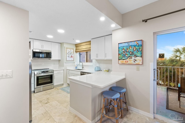 kitchen with stainless steel appliances, sink, light tile patterned floors, and backsplash