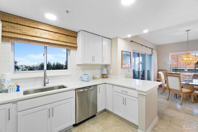 kitchen with a healthy amount of sunlight, sink, white cabinets, and stainless steel dishwasher