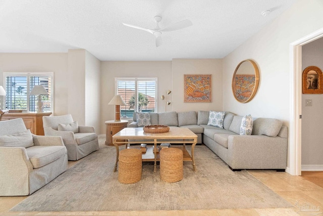 living room featuring light tile patterned flooring and ceiling fan