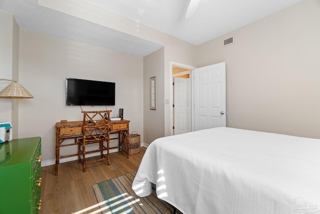 bedroom with light hardwood / wood-style flooring and ceiling fan