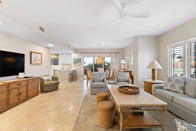 tiled living room featuring ceiling fan