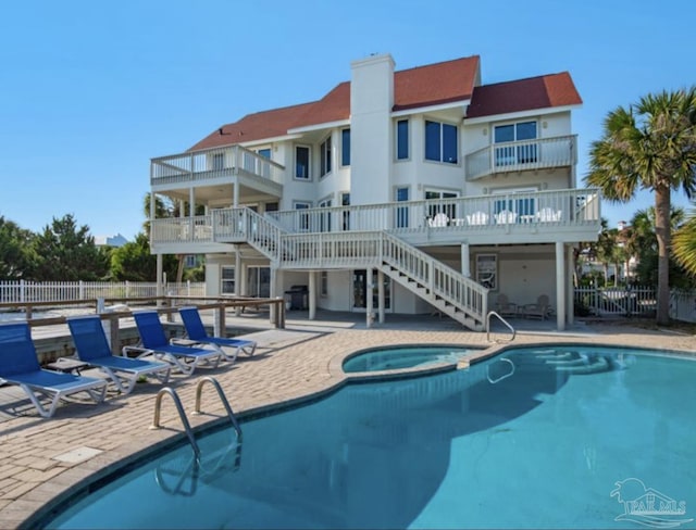 view of pool with a patio area and a hot tub