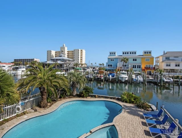 view of swimming pool with a patio and a water view