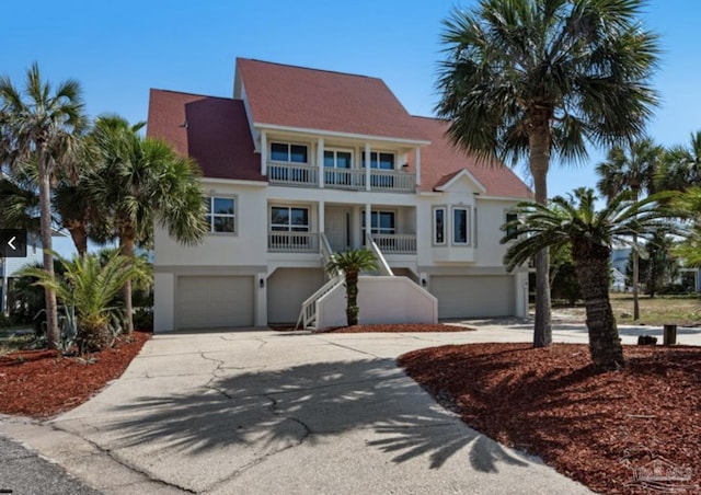 view of front of home featuring a garage and a balcony