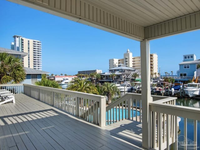 deck with a swimming pool and a water view