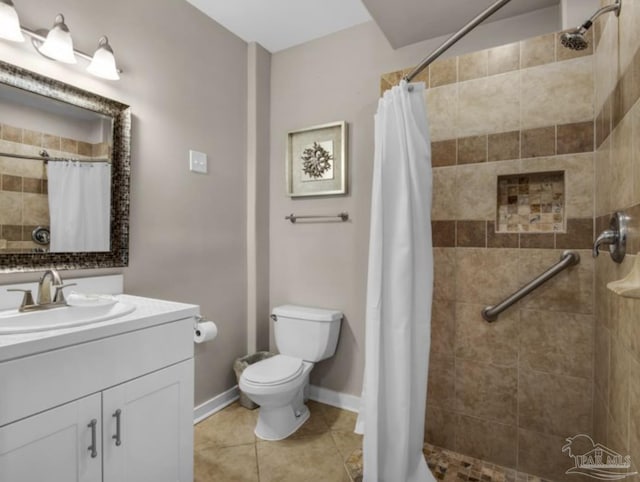 bathroom with vanity, tile patterned floors, toilet, and walk in shower