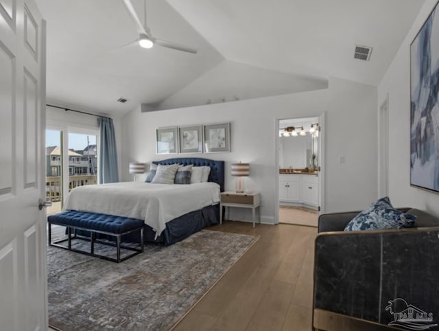 bedroom with hardwood / wood-style floors, lofted ceiling, access to outside, ceiling fan, and ensuite bath