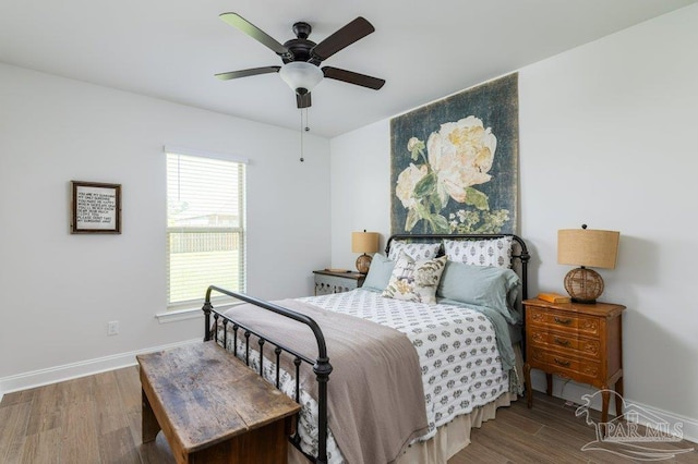 2929 Trestle Way, Cantonment, FL 32533 - bedroom with baseboards, multiple windows, a ceiling fan, and wood finished floors