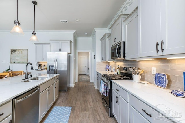 2929 Trestle Way, Cantonment, FL 32533 - kitchen with visible vents, ornamental molding, a sink, appliances with stainless steel finishes, and decorative light fixtures