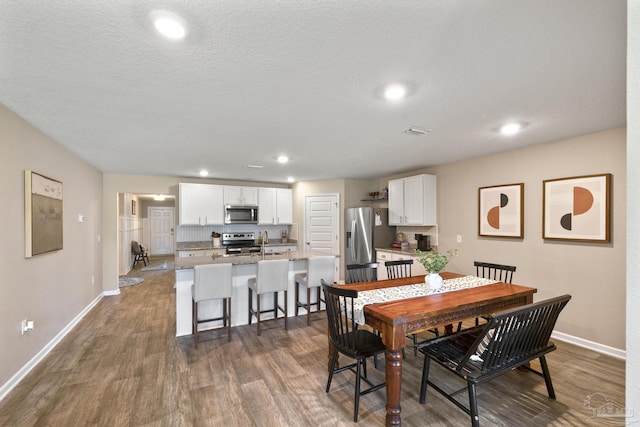 5711 Guinevere Ln, Milton, FL 32583 - dining space with visible vents, baseboards, a textured ceiling, dark wood-style floors, and recessed lighting