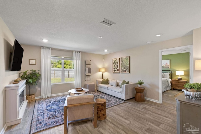 5711 Guinevere Ln, Milton, FL 32583 - living room with wood finished floors, baseboards, visible vents, and recessed lighting