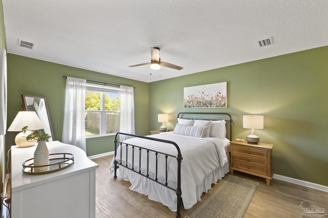 5711 Guinevere Ln, Milton, FL 32583 - bedroom featuring light wood-type flooring, baseboards, a ceiling fan, and visible vents