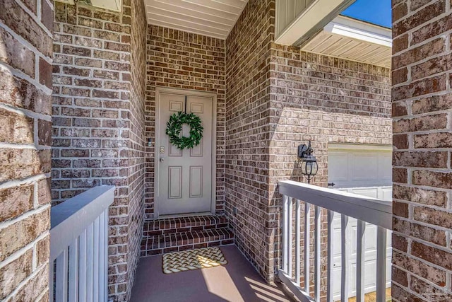 5711 Guinevere Ln, Milton, FL 32583 - view of exterior entry featuring brick siding and a garage
