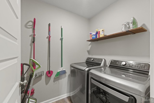 5711 Guinevere Ln, Milton, FL 32583 - washroom with independent washer and dryer, laundry area, baseboards, and wood finished floors
