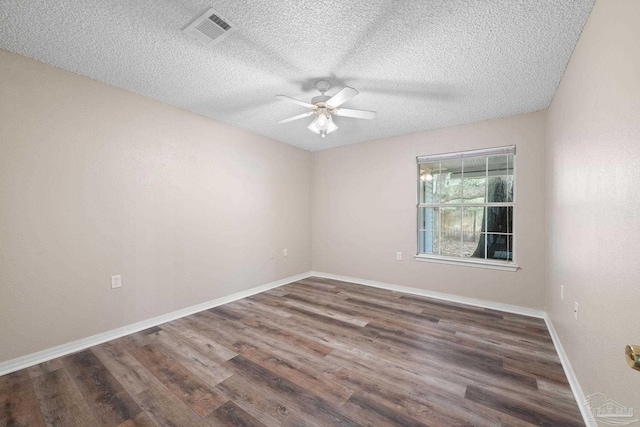 empty room featuring dark hardwood / wood-style floors, a textured ceiling, and ceiling fan