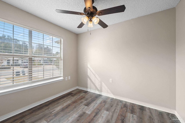 unfurnished room with ceiling fan, dark wood-type flooring, and a textured ceiling