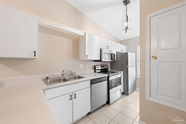 kitchen with sink, white cabinetry, hanging light fixtures, light tile patterned floors, and stainless steel appliances