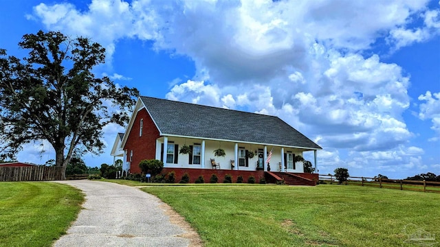 view of front of home with covered porch and a front yard