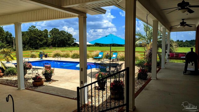 view of swimming pool featuring a patio area and ceiling fan