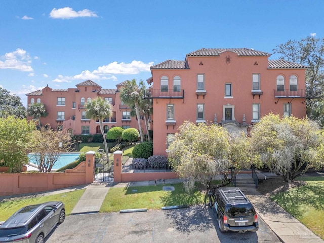 view of property with a fenced front yard and uncovered parking